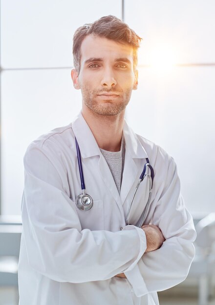 man smiling and looking at camera doctor student intern with stethoscope