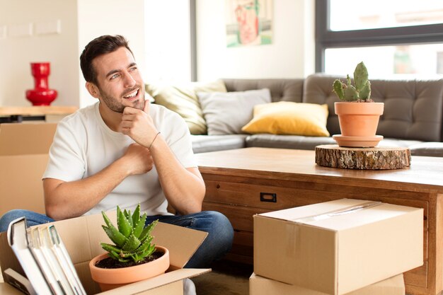 man smiling with a happy, confident expression with hand on chin, wondering and man looking to the side