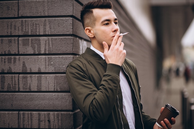 Man smoking and drinking coffee