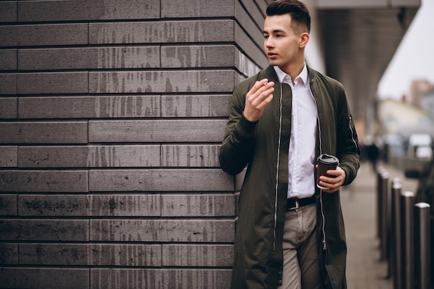 Man smoking and drinking coffee