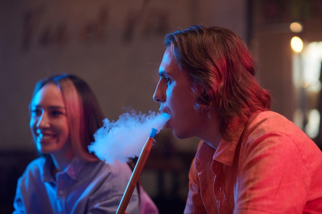 Man Smoking Hookah with Friends