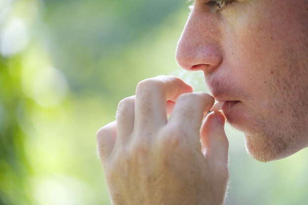 man smoking in nature