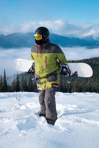 Man snowboarder portrait carpathian mountains on background winter sport