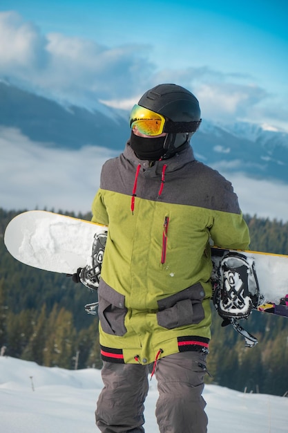 Man snowboarder portrait carpathian mountains on background winter sport