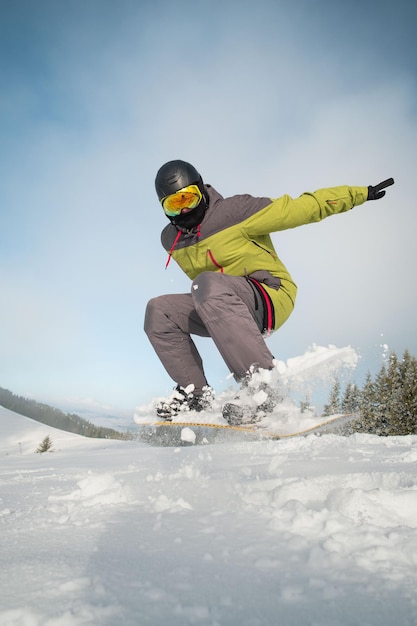 Man snowboarder portrait carpathian mountains on background winter sport