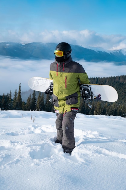 Man snowboarder portrait carpathian mountains on background