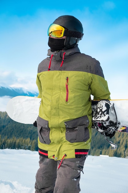 Man snowboarder portrait carpathian mountains on background