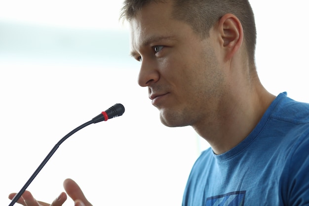 Man speaks in front microphone informal meeting portrait