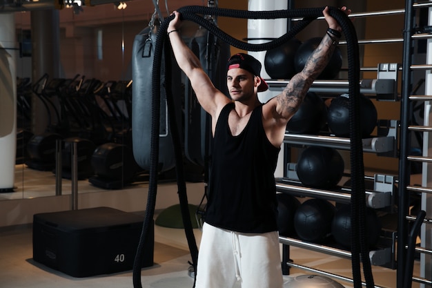 man in sportswear is training in the gym