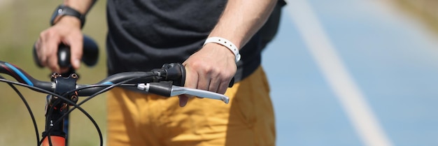 Man in sportswear standing near mountain bike