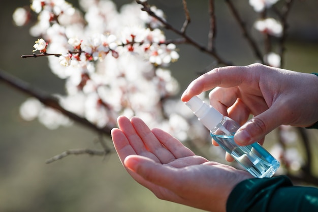 Man spraying hand sanitizer on hand