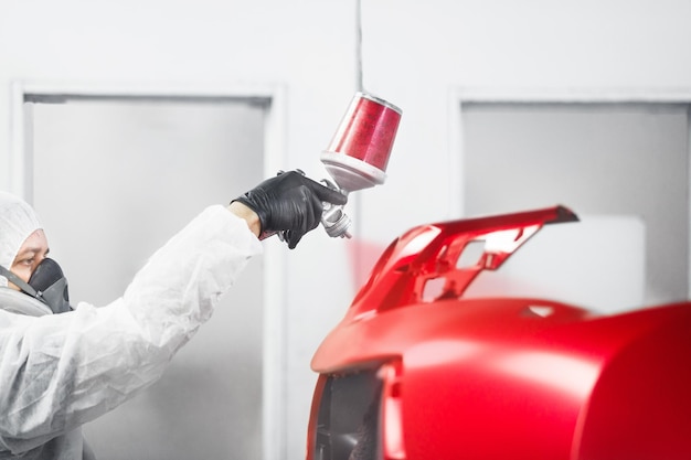 Man sprays red dye on the elements of the vehicle