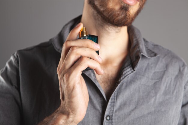 Man sprinkles perfume on himself