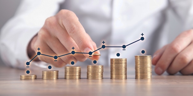 Man stacking coins with a graph of profit.