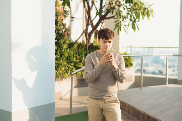 A man stading isolated and using phone