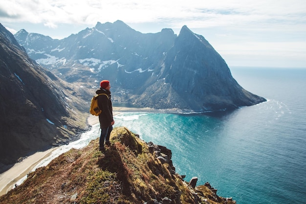 Photo man stand on cliff edge alone enjoying aerial view backpacking lifestyle travel adventure outdoor