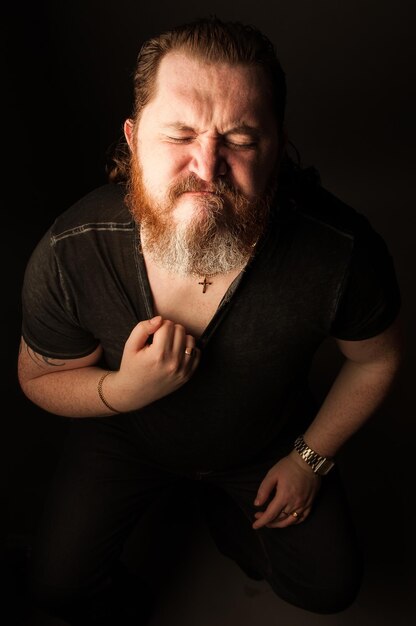 Man standing against black background