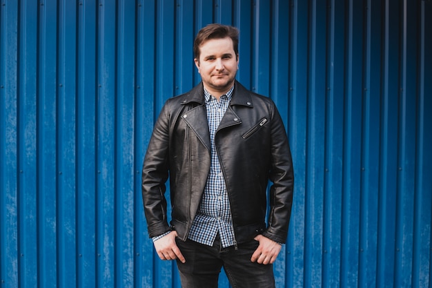 Man standing on the background of blue wall