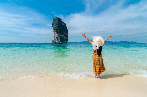 Man standing at beach against sky