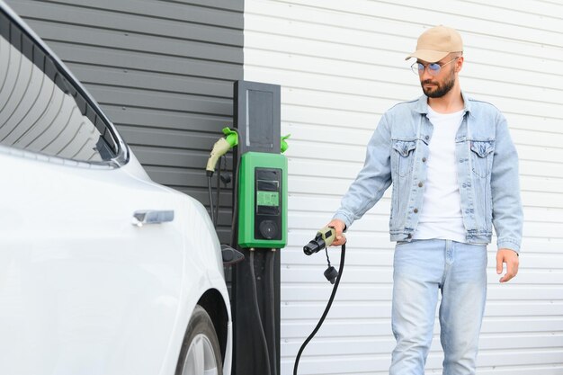 Man standing by his electric car