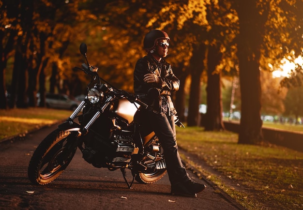 man standing by motorcycle