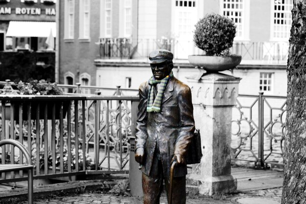 Man standing by railing in city