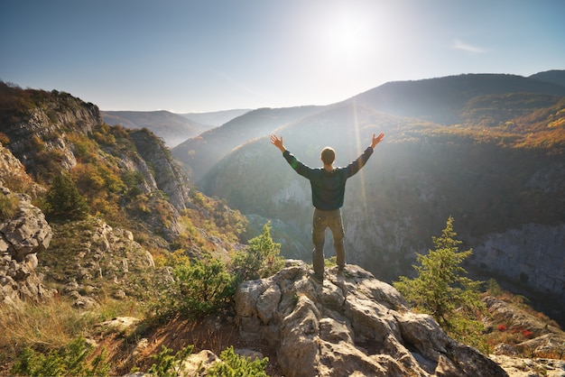 Man standing on the cliff in mountain.