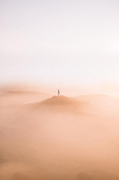 man standing on desert against clear sky