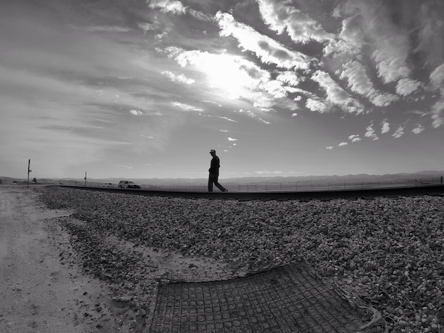 Man standing on field against sky