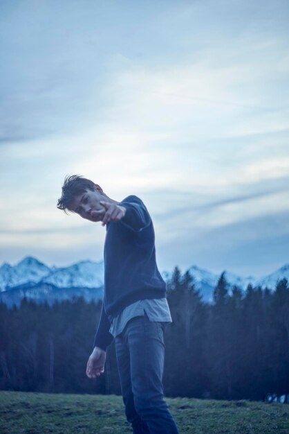 Man standing on field against sky