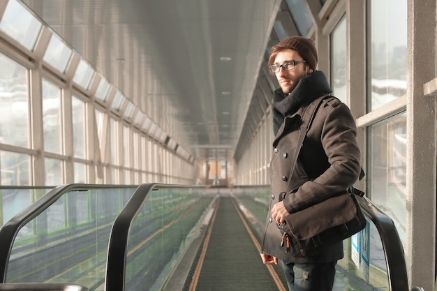 man standing in front of escalator in underground passage