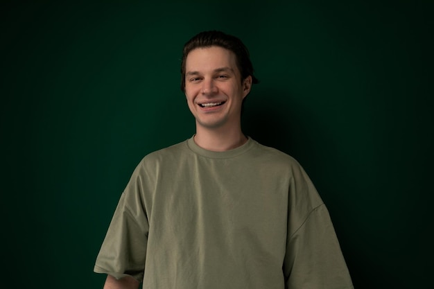 Man standing in front of green wall