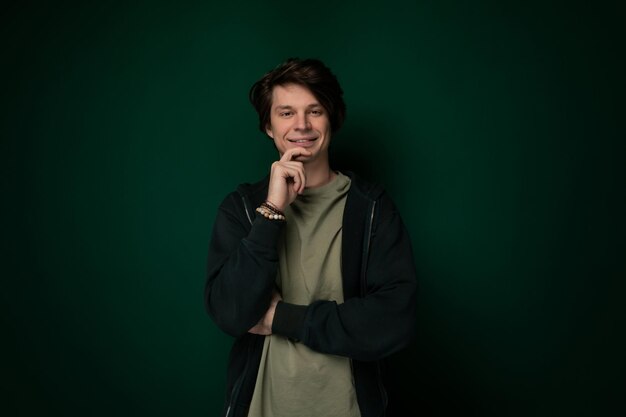 Man standing in front of green wall