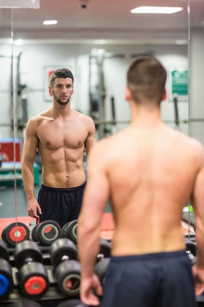 Man standing in front of large mirror