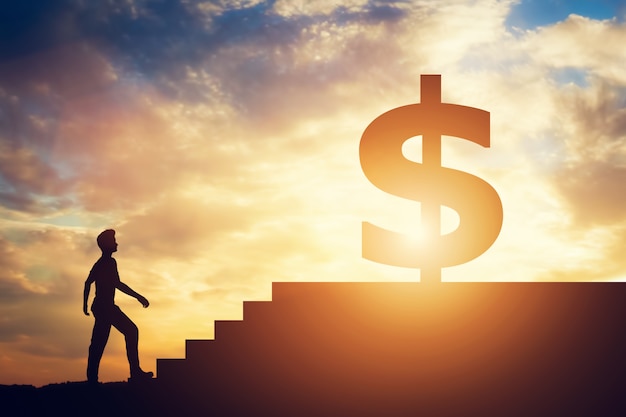 Man standing in front of stairs with dollar sign on top