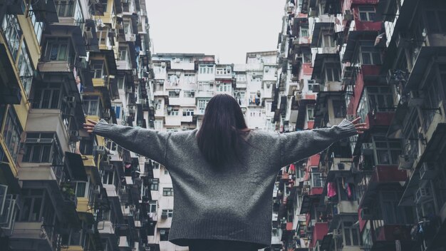 Man standing in front of Yick fat building, Hongkong