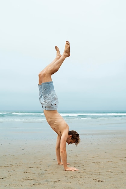 Photo man standing on hands full shot