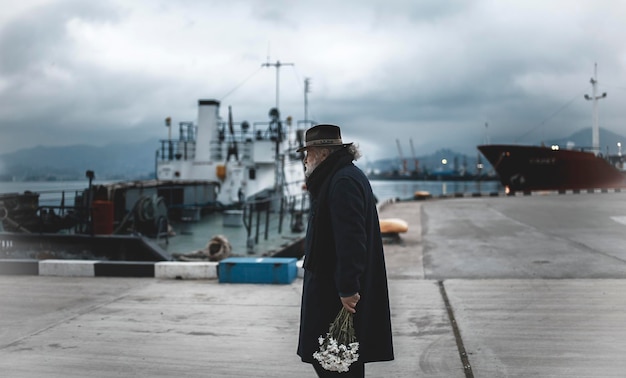 man standing at harbor against sky