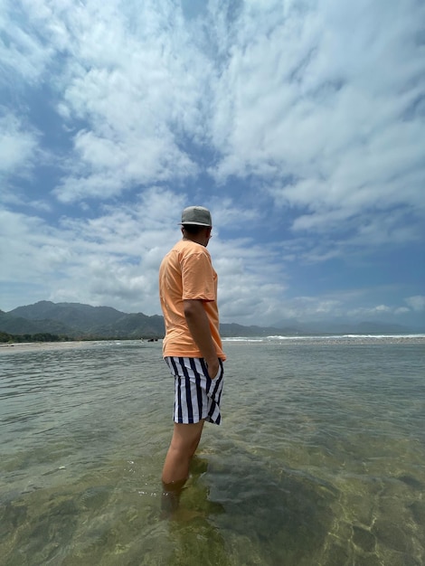 Man standing on his back in the river