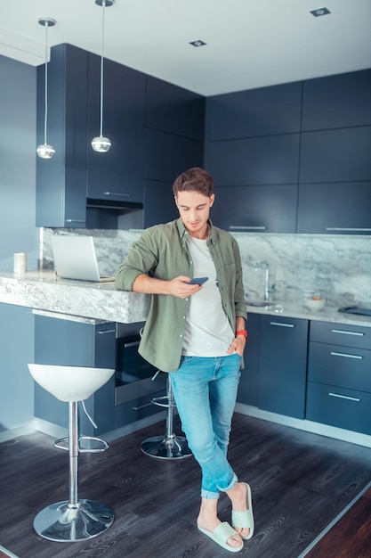 Man standing in his spacious modern kitchen