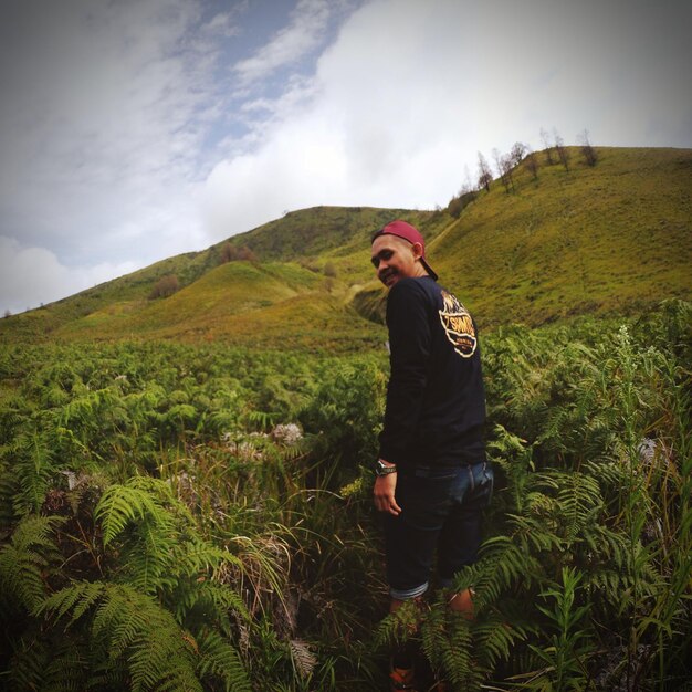 Man standing on mountain against sky