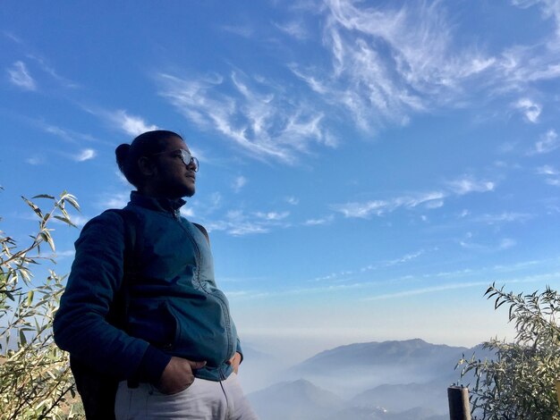 Man standing on mountain against sky