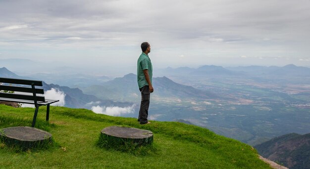 Man standing on mountain against sky