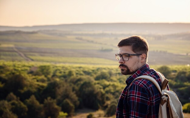 A man standing on a mountain as the sun sets