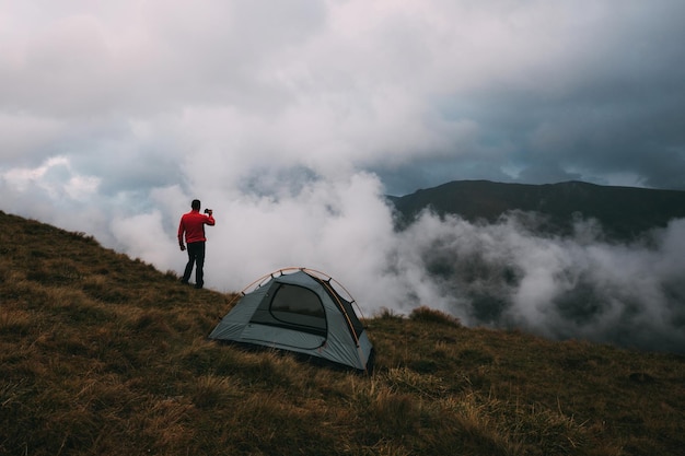 Man standing on mountain road against sky
