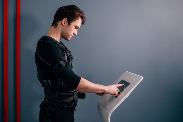 Man standing near an EMS machine