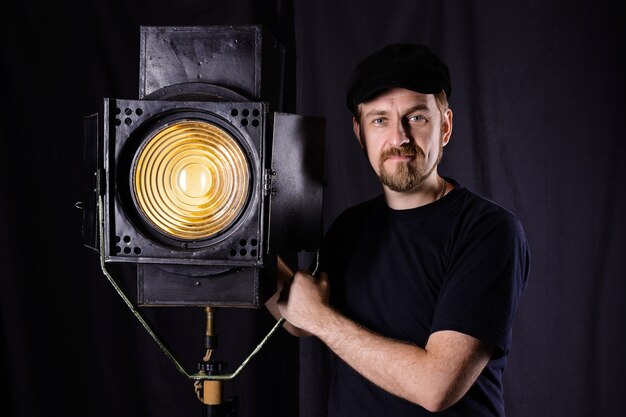 man standing near a film projector