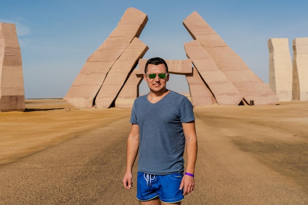 Man standing near huge gate of allah ras mohammed national park\
in egypt desert