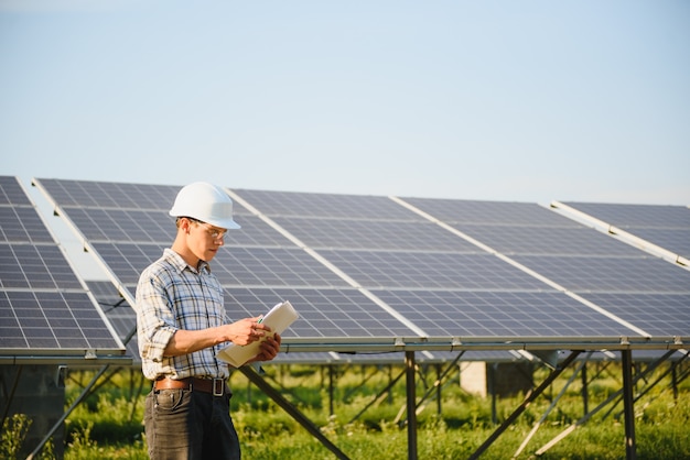 Man standing near solar panels