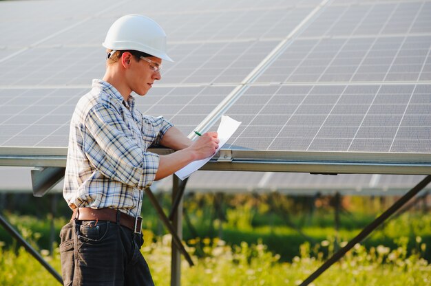 Man standing near solar panels